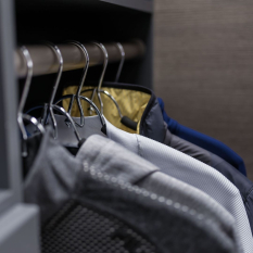 Custom Grey Reach-in Closet with shoe fences, double hang for short hang clothes and medium hang for dress shirts. Lots of upper adjustable shelves.