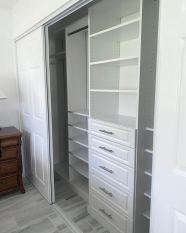 Custom Reach-in Closet Floor Based System with raised panel door faces. Long hang and short hang sections. Adjustable shoe shelves.