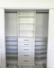 Custom Reach-in Closet Floor Based System with raised panel door faces. Long hang and short hang sections. Adjustable shoe shelves.