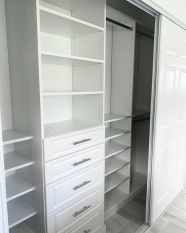 Custom Reach-in Closet Floor Based System with raised panel door faces. Long hang and short hang sections. Adjustable shoe shelves.