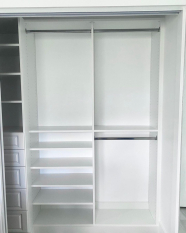Custom Reach-in Closet Floor Based System with raised panel door faces. Long hang and short hang sections. Adjustable shoe shelves.