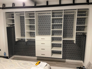 Floating-Wall-Based-Reach-in-Closet-with-Drawer-Bank