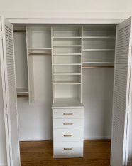 Small-Reach-in-Closet-with-Drawer-Bank-and-Gold-Rods