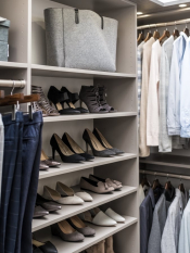 Storm or Fog Grey Walk-in Closet with grey woodgrain door and drawer faces. LED Lighting along the system. His and her side with shoe shelving, hanging and upper storage