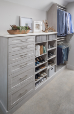 Walk-in Closet Ivory Woodgrain Finish with Shaker Doors. His and her sides of the closet with pull out closet laundry.