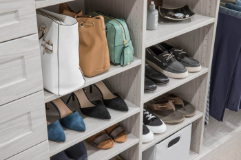 Walk-in Closet Ivory Woodgrain Finish with Shaker Doors. His and her sides of the closet with pull out closet laundry.