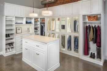 White Raised Panel Walk-in Closet Portland and Lake Oswego. Island with marble top. Glass display case with LED lighting along the sides. Birch dovetail drawers. Pull out jewelry tray organizers and wire laundry baskets.