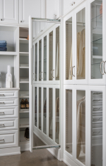 White Raised Panel Walk-in Closet Portland and Lake Oswego. Island with marble top. Glass display case with LED lighting along the sides. Birch dovetail drawers. Pull out jewelry tray organizers and wire laundry baskets.