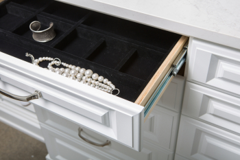 White Raised Panel Walk-in Closet Portland and Lake Oswego. Island with marble top. Glass display case with LED lighting along the sides. Birch dovetail drawers. Pull out jewelry tray organizers and wire laundry baskets.