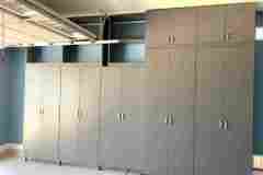 Storm grey custom garage cabinets with doors and upper cabinets.