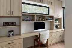 Wood grain home office with upper cabinets, adjustable shleving, long desk work surface, lower filing cabinets and drawers
