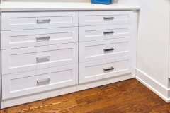 Built in dresser in mens walk in closet with silestone countertop