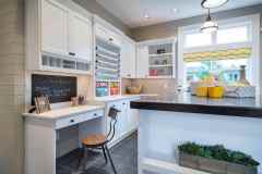 Custom craft room with desk area for workspace and countertops. Upper and lower cabinet storage.