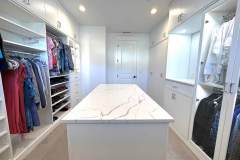 Luxury high-end custom Walk-in Close design with LED lighting, eased edge rounded drawer and door faces, glass display cases for handbags and purses, stone countertop, shoe fences, hanging, and more.
