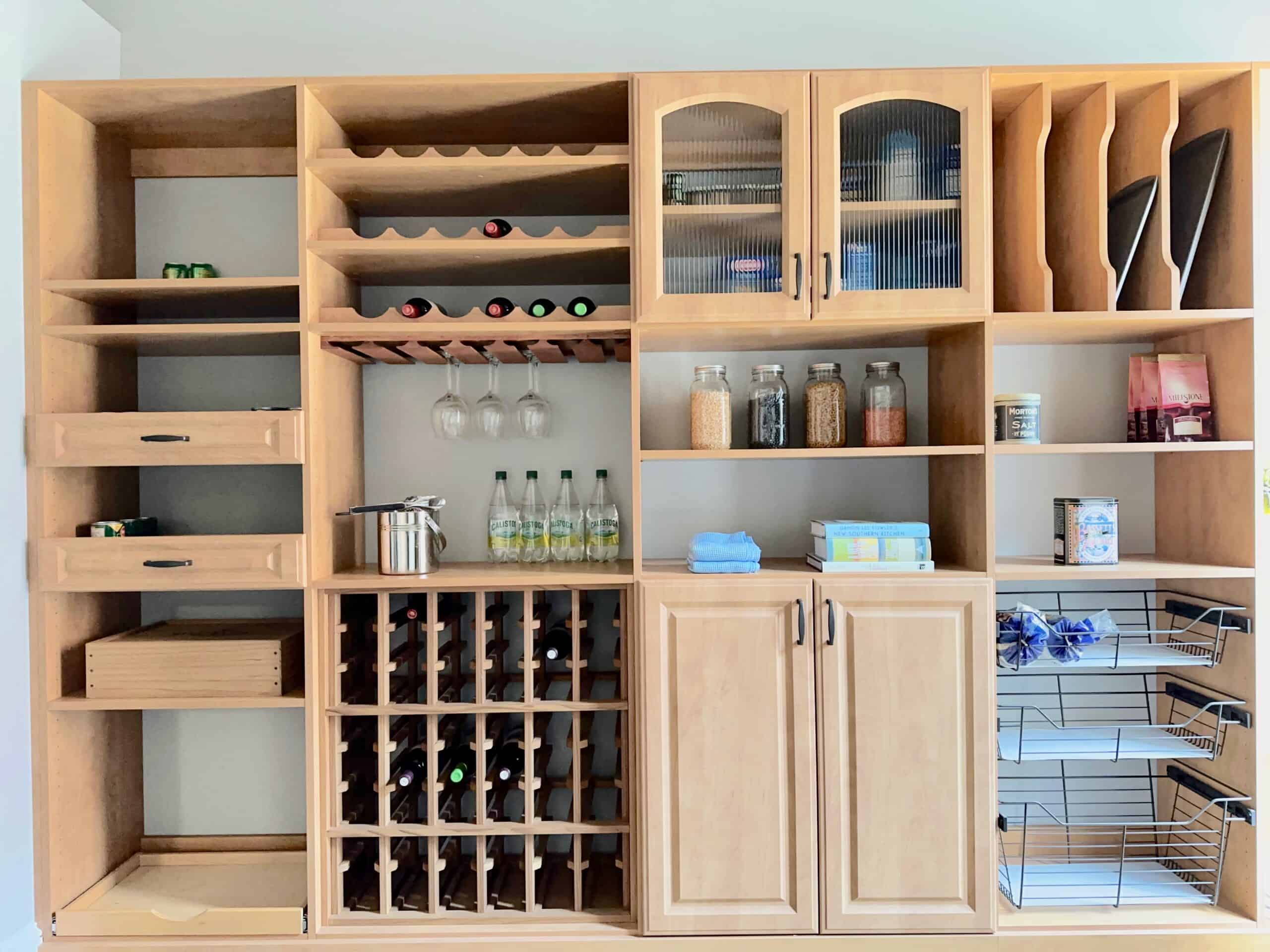 Custom pantry cabinets and storage with maple finish. Glass reed doors. Pull-out trays, adjustable shelving, wine rack storage, wine glass storage, and pull-out wire basket
