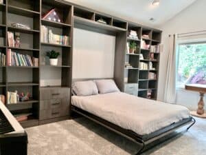 Queen Murphy Bed Built-in Wall to Wall with drawers on each side and book shelving floor to ceiling and wall to wall. Pewter Pine finish.
