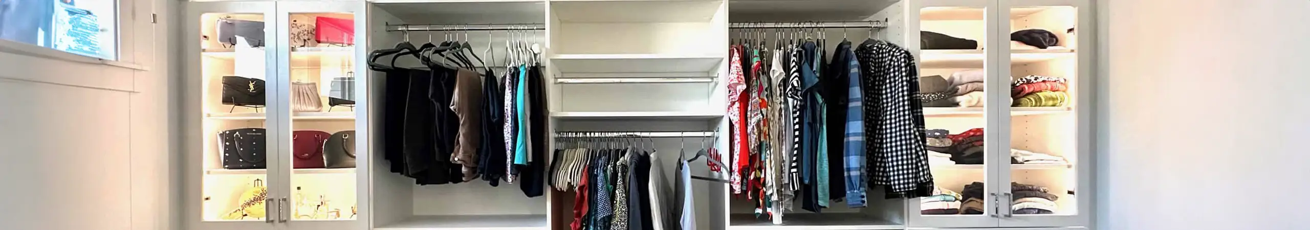 Custom walk-in closet by Portland Closet featuring built-in shelving, hanging rods, and a shoe rack