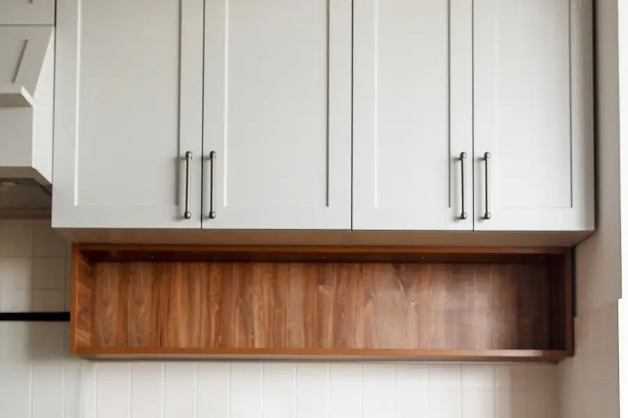Custom wall cabinets in kitchen interior with stainless steel handles